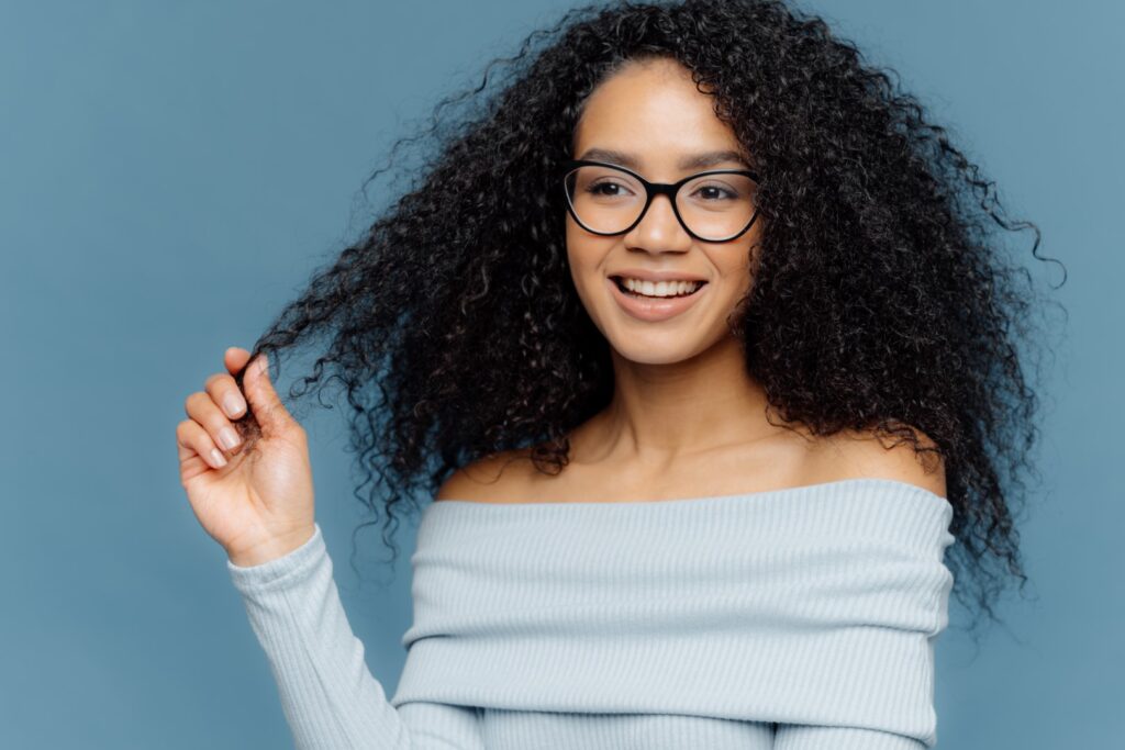 black woman wearing a curly wig