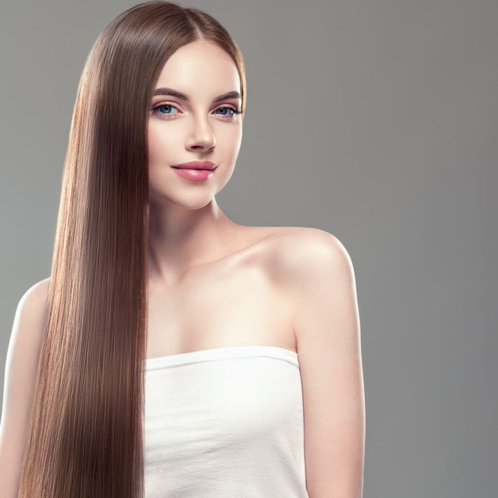 Woman with sleek, straight hair after a professional hair straightening service.