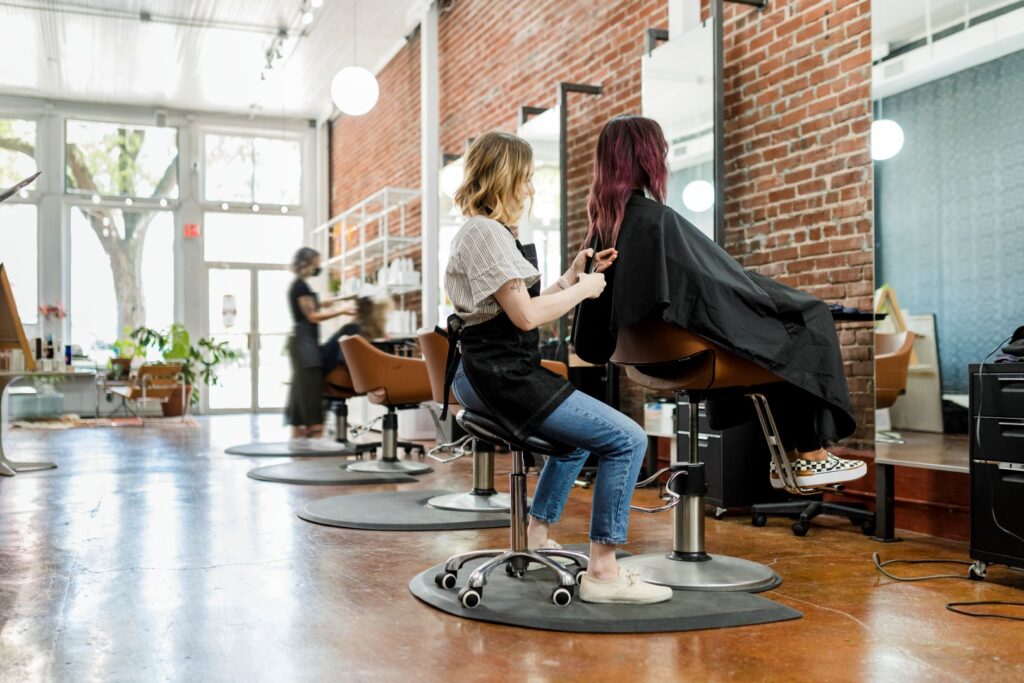 Hair stylist giving a haircut at a modern hair salon.